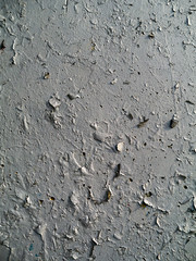 Cracked paint on a wall abstract background texture. Monochromatic tone.