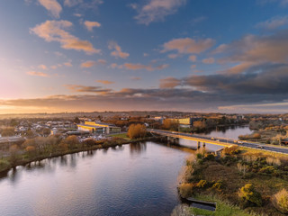Fototapeta na wymiar Sunset over Galway city and river Corrib, Blue cloudy sky, aerial view. Bridge over water. Ireland.