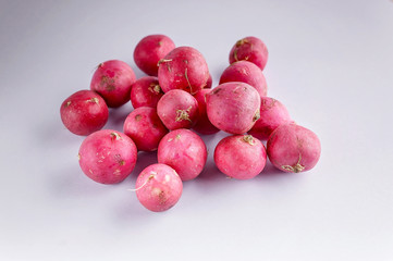 Red radish on a light gray background. Fresh and healthy vegetables. Organic product