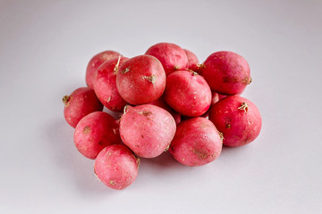 Red radish on a light gray background. Fresh and healthy vegetables. Organic product