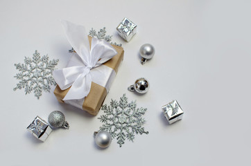 silver decorations and present on a white background