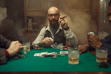 Bearded poker player with cigar, casino