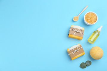 Flat lay composition with natural handmade soap on light blue background. Space for text