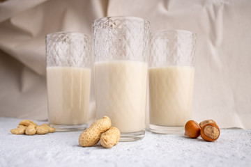 Three glasses with different types of organic milk. Nut milk without lactose, gmo, antibiotics and casein. Diet drink.