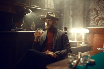 Poker player drinks whiskey in casino bar