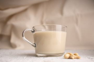 Glass cup with organic milk. Nut milk without lactose, gmo, antibiotics and casein. Diet drink. ..