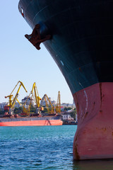 nose of a transport ship with an anchor and mooring ropes