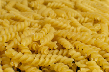 background formed by spiral shaped pasta. texture.