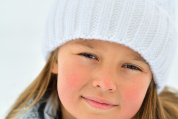 Happy child girl on winter walk outdoors . little child playing in winter holidays. Girl in winter lake. Portrait