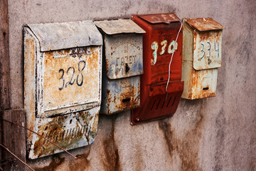 Old-fashioned russian mailboxes on the stucco wall