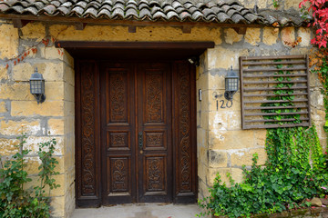 Fototapeta na wymiar Ornate carved wood doorway in the Fall at ancient hillside village of Yesilyurt Malatya Turkey