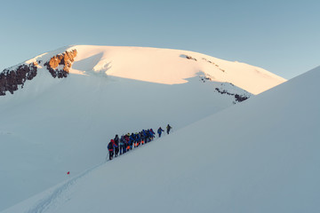 Group of mountaineers climbing in the snowy mountain peaks
