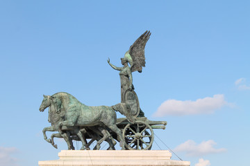 The Quadriga of Unity of Victor Emmanuel in Piazza Venezia in Rome in Italy, at the top of the Altare della Patria. Statue shot at bright day.