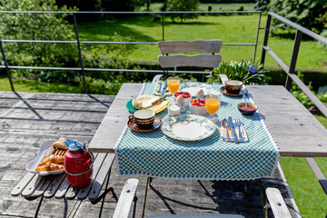 Breakfast served with coffee, orange juice, croissants, cheese and fruits on the village terrace. Balanced diet. - 311240008
