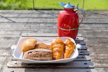 fresh Breakfast: a pot of coffee, a plate of croissants. Stand on the table on the summervillage veranda - 311240013