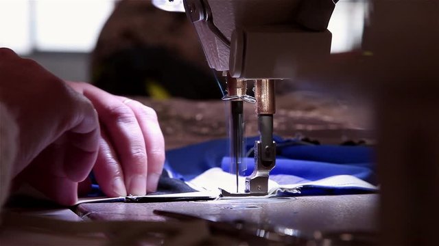 Woman working textile industrial sewing machine