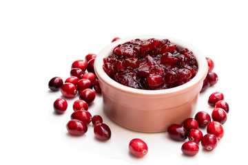 Fresh cranberries in ceramic pot isolated on white