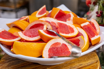 Sliced delicious grapefruit lie on a plate