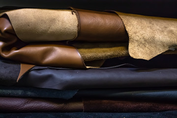 Rolls of genuine leather in the workshop. Convolutions of vegetable tanned leather.