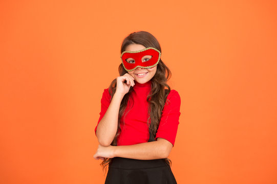 New year party. Carnival party. Masquerade concept. Kid wear eye mask. Girl wear mask orange background. Event and entertainment. Party celebration. Rock this party. Visit public event anonymously