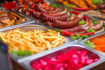 Various food at the annual christmas fair. Fried sausages, french fries and other tasty food