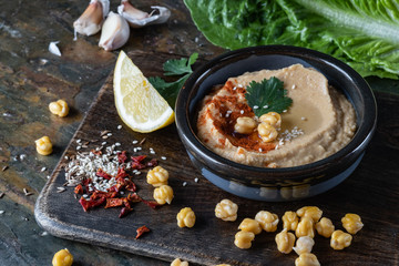 Chickpeas hummus with olive oil and smoked paprika, selective focus, and Pita Chips