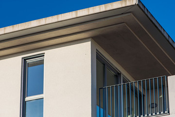 House facade with balcony and roof overhang