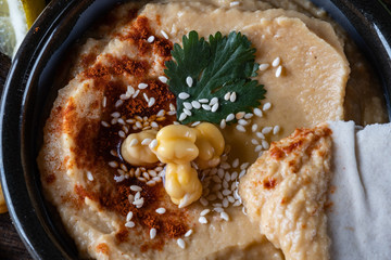 Chickpeas hummus with olive oil and smoked paprika, selective focus, and Pita Chips