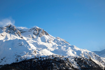 Fototapeta na wymiar Tops of mountains with snow in St. Moritz in switzerland