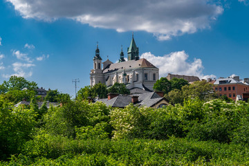 Fototapeta na wymiar Church over treetops in Lublin, Poland