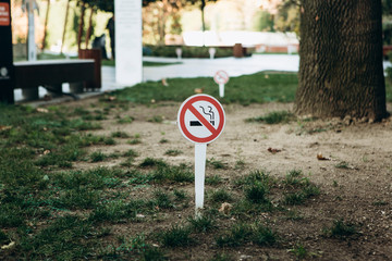 No smoking warning sign in the park. Smoking free area. Prohibition sign.