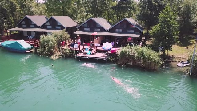 Two guys swimming in a river in Ada Bojana