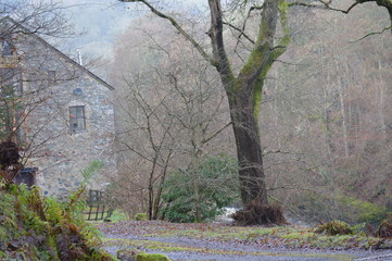 Old textile mill on the banks of the River Ericht at Blairgowrie on a cold, misty, December day