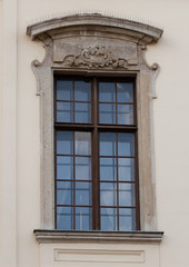 Fototapeta na wymiar Window with decorated stone frame wooden window frame