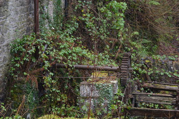 Remains of a water mill seen on a walk along the banks of the River Ericht at Blairgowrie on a cold, misty, December day