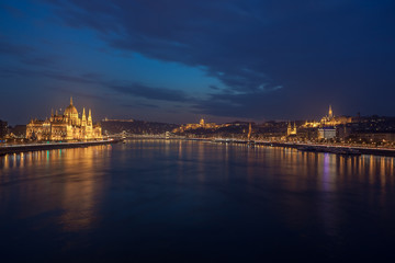 Fototapeta na wymiar Incredible Evening View of Budapest parliament and Danube river at sunset, Hungary.