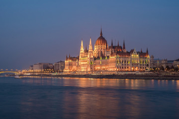 Fototapeta na wymiar Hungarian Parliament building and Danube River in the Budapest city in the evening. A sample of neo-gothic architecture.