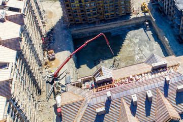 Construction of a multi-storey residential complex. Aerial view. Pouring concrete Foundation of one of the buildings. 