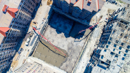 Construction of a multi-storey residential complex. Aerial view. Pouring concrete Foundation of one of the buildings. 