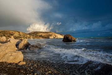 Beautiful landscape sunset in the sea with stones and mountains