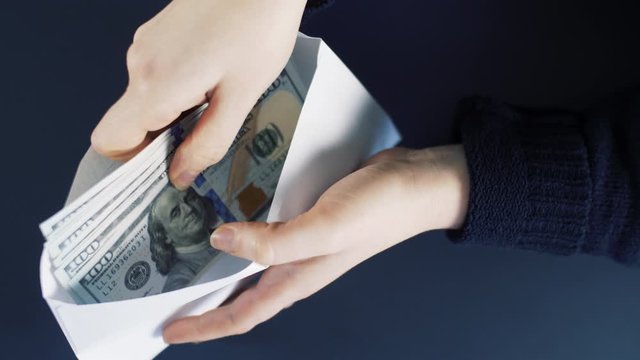 Money counting in white envelope. Close up  of money dollar notes. Business cash counting. 4k slow motion.