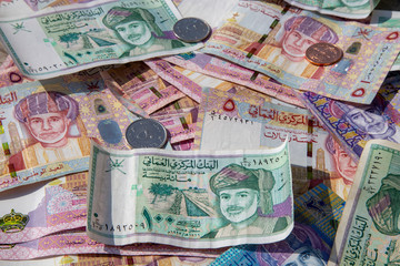 Fototapeta na wymiar Closeup view of different banknotes and coins of omani rials