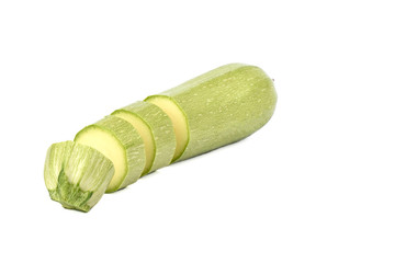 Green ripe squash cut into slices isolated on a white background.