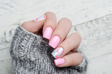 Pink manicure with pink flamingo pattern with gray sweater