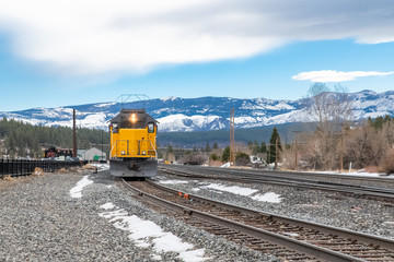 A train crossing in Truckee, Nevada, with snowy mountains in background