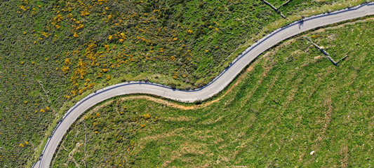 Aerial drone ultra wide photo of snake road crossing hill in Mediterranean destination