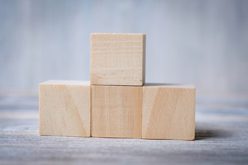 Wooden cubes against a grey background. Mock up.