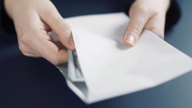 Money counting in white envelope. Close up  of money dollar notes. Business cash counting. 4k slow motion.