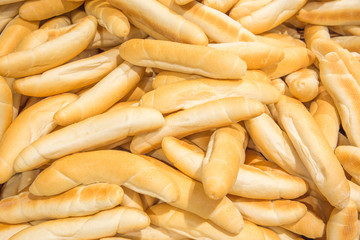 Delicious fresh baked fragrant white pastry bread from central europe, called Rohlik in Czech. Filled frame texture.