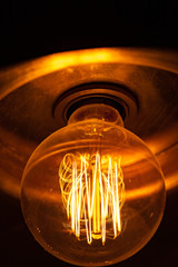 The old incandescent lamp glows yellow.